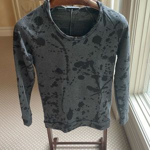 Hoodie sweatshirt with splatter paint pattern.